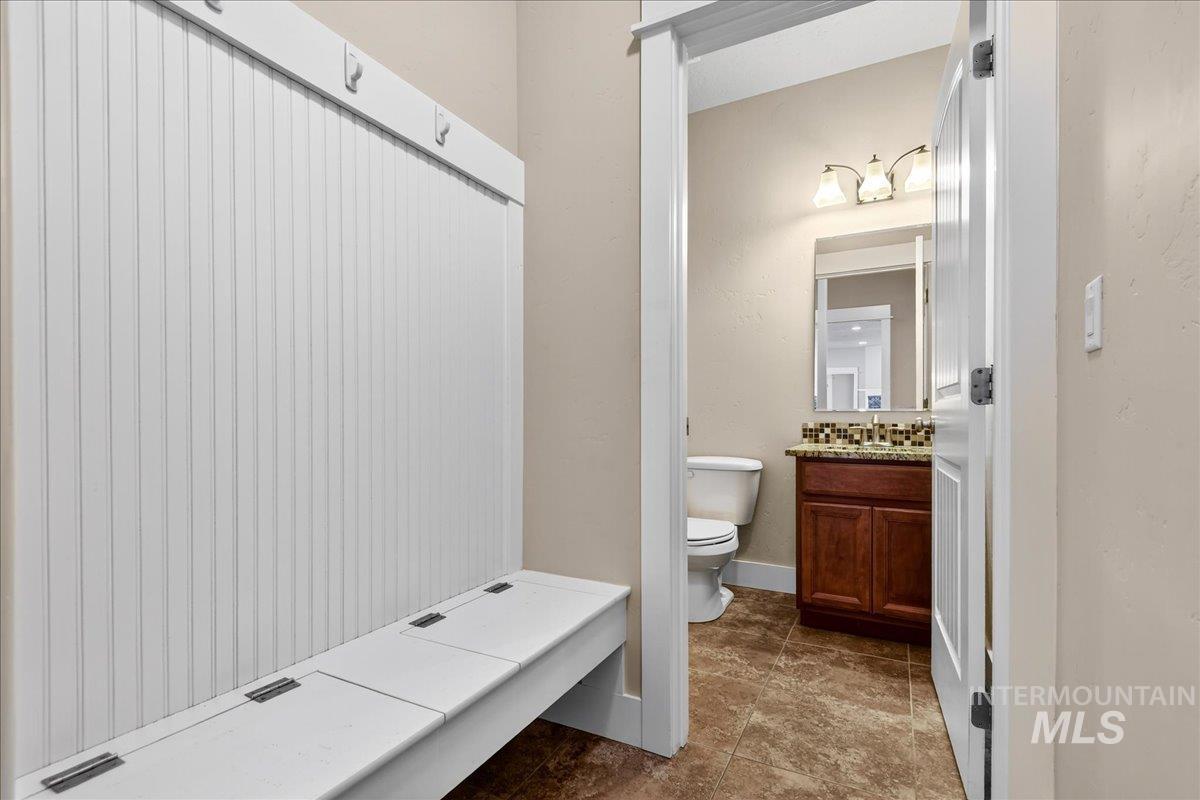 Full bathroom featuring vanity, a shower, and dark tile patterned floors