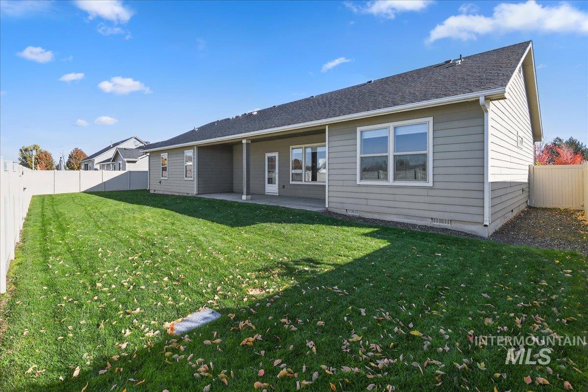Back of house featuring a fenced backyard and a patio