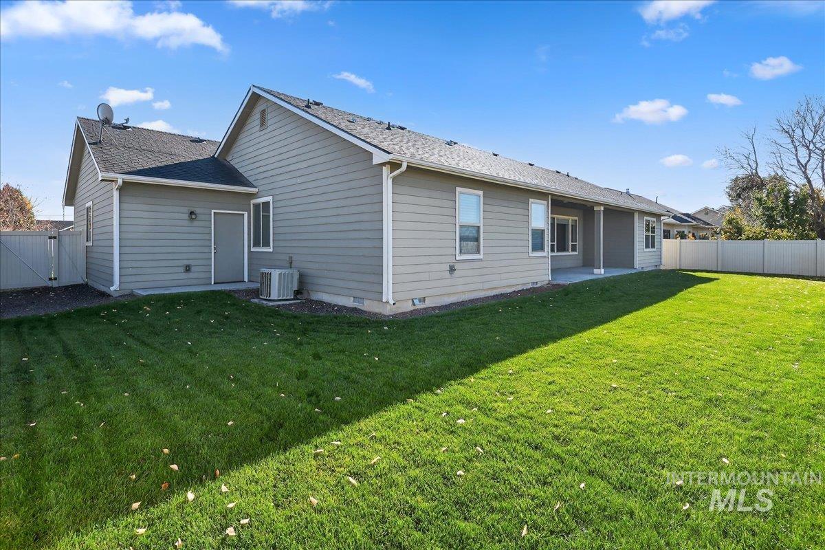 Rear view of property featuring a fenced backyard and a patio area