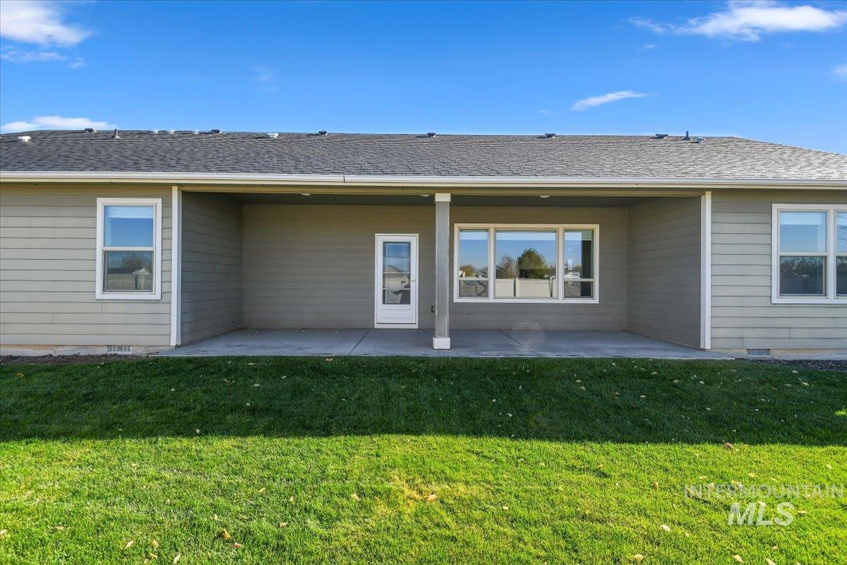 Back of property with a patio and a yard