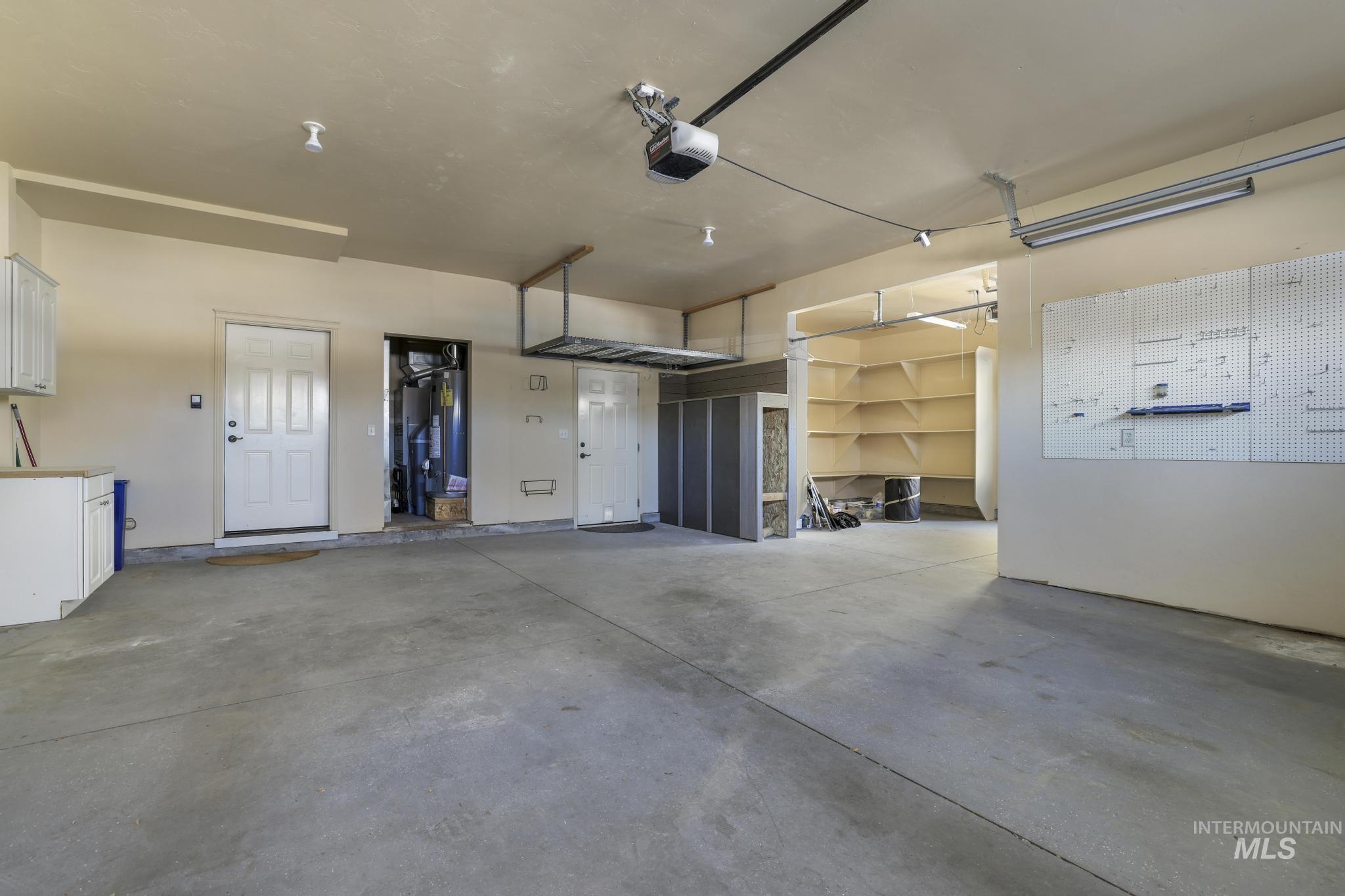 Garage with water heater and a garage door opener