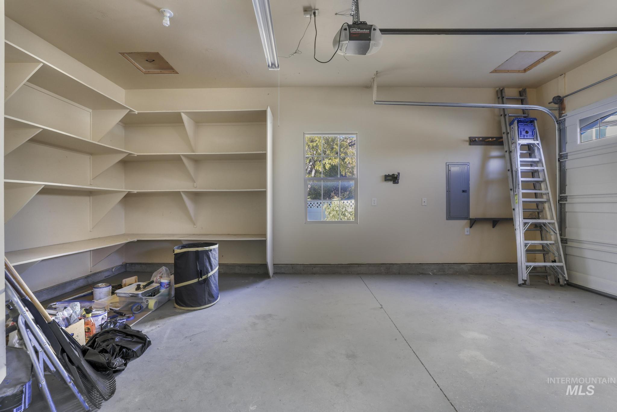 Garage with a garage door opener and electric panel