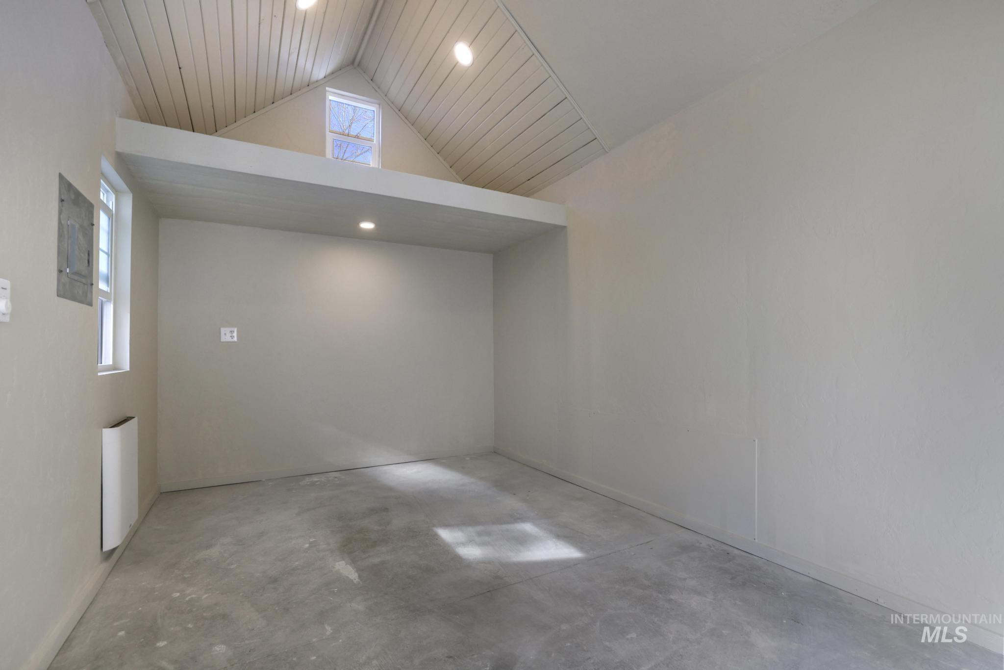 Additional living space featuring unfinished concrete flooring, recessed lighting, vaulted ceiling, and wood ceiling