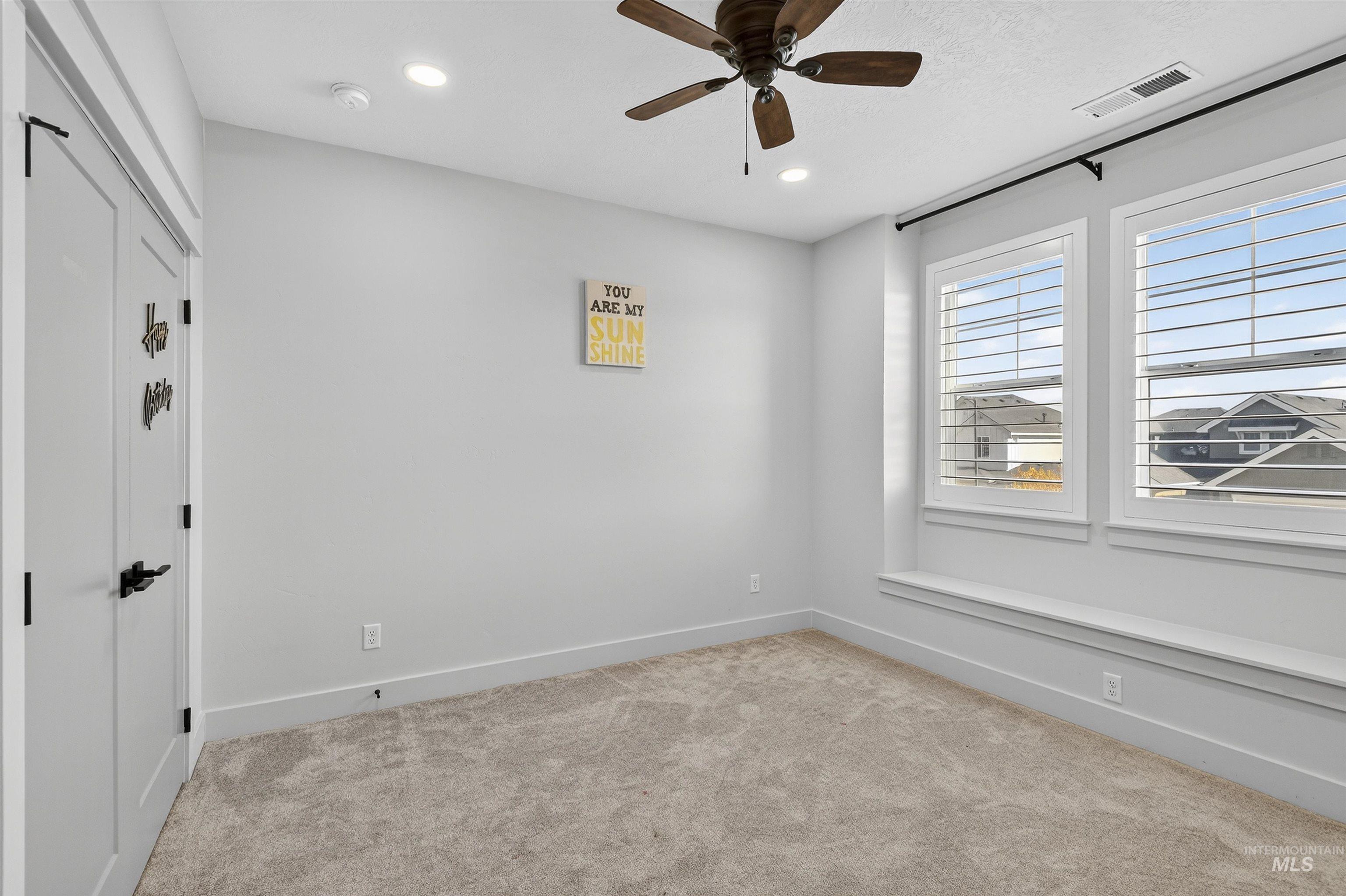 Spare room with light carpet, a ceiling fan, and recessed lighting