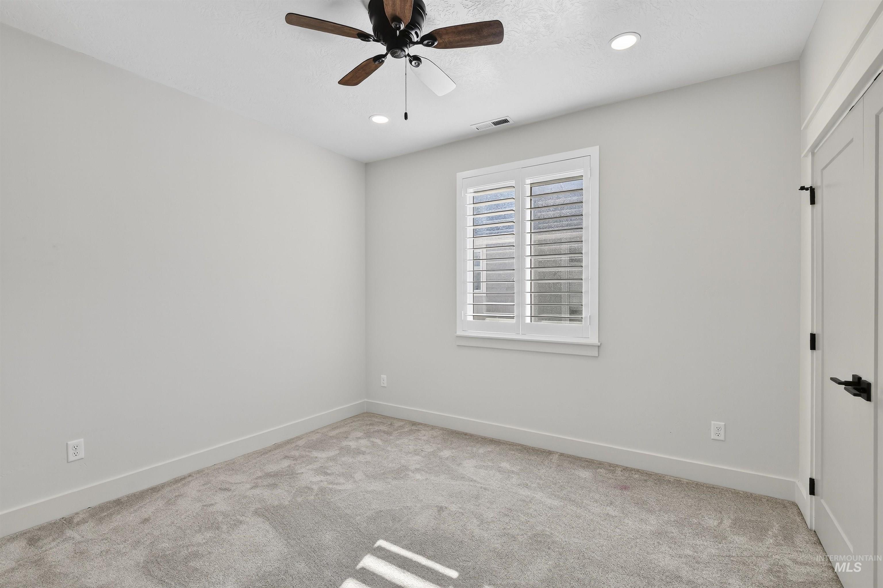 Unfurnished room featuring light carpet, recessed lighting, and a ceiling fan