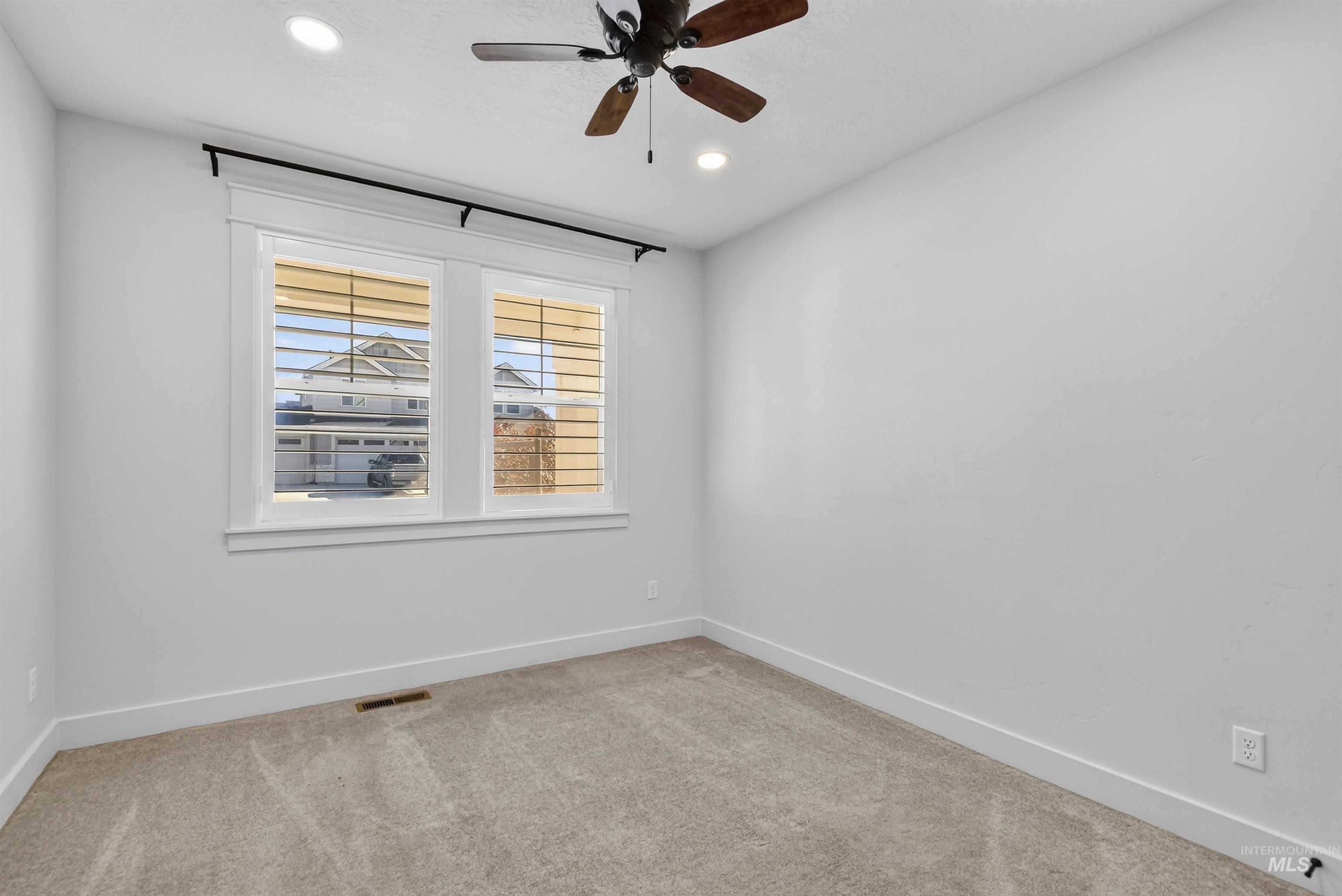 Spare room with light colored carpet, recessed lighting, and ceiling fan