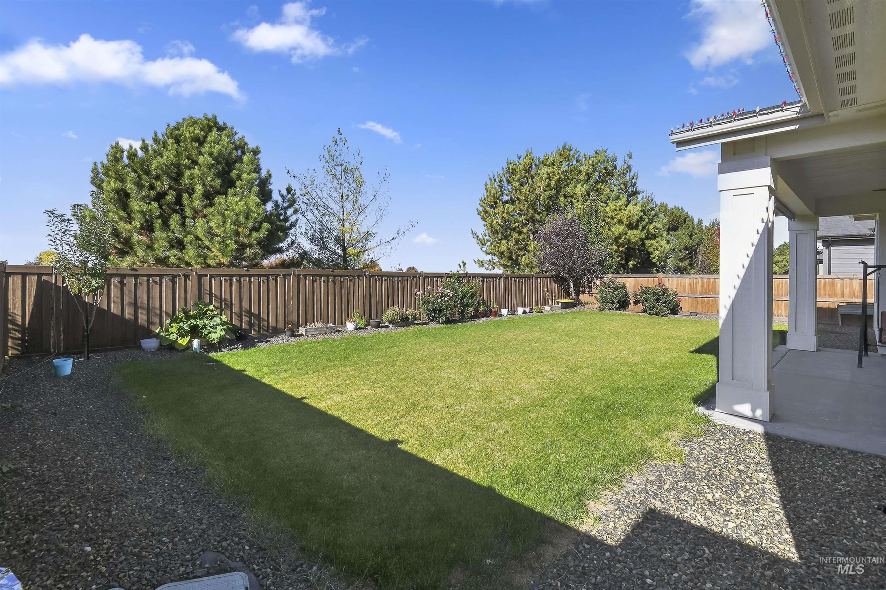 Fenced backyard with a patio