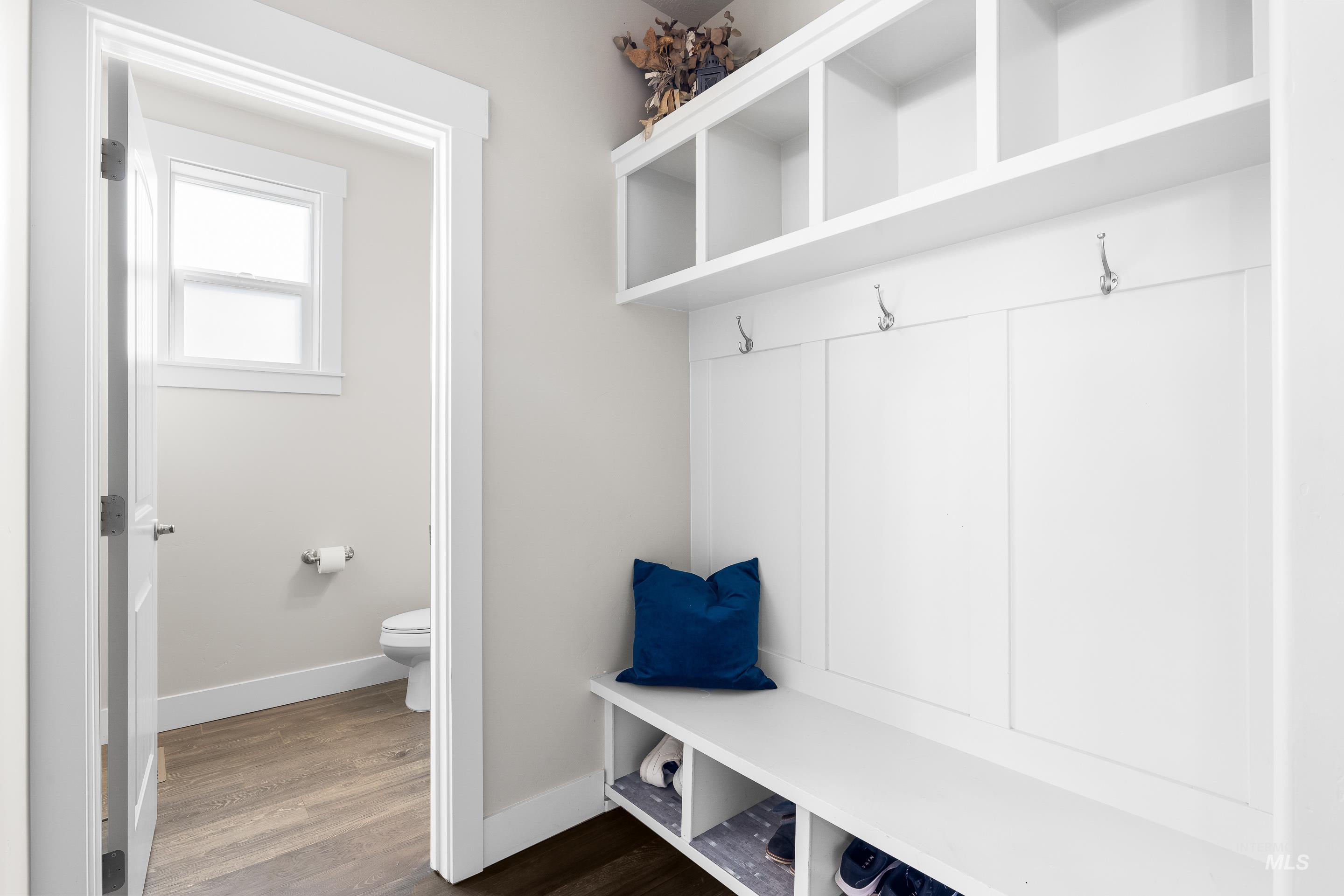 Mudroom with baseboards and dark wood-type flooring