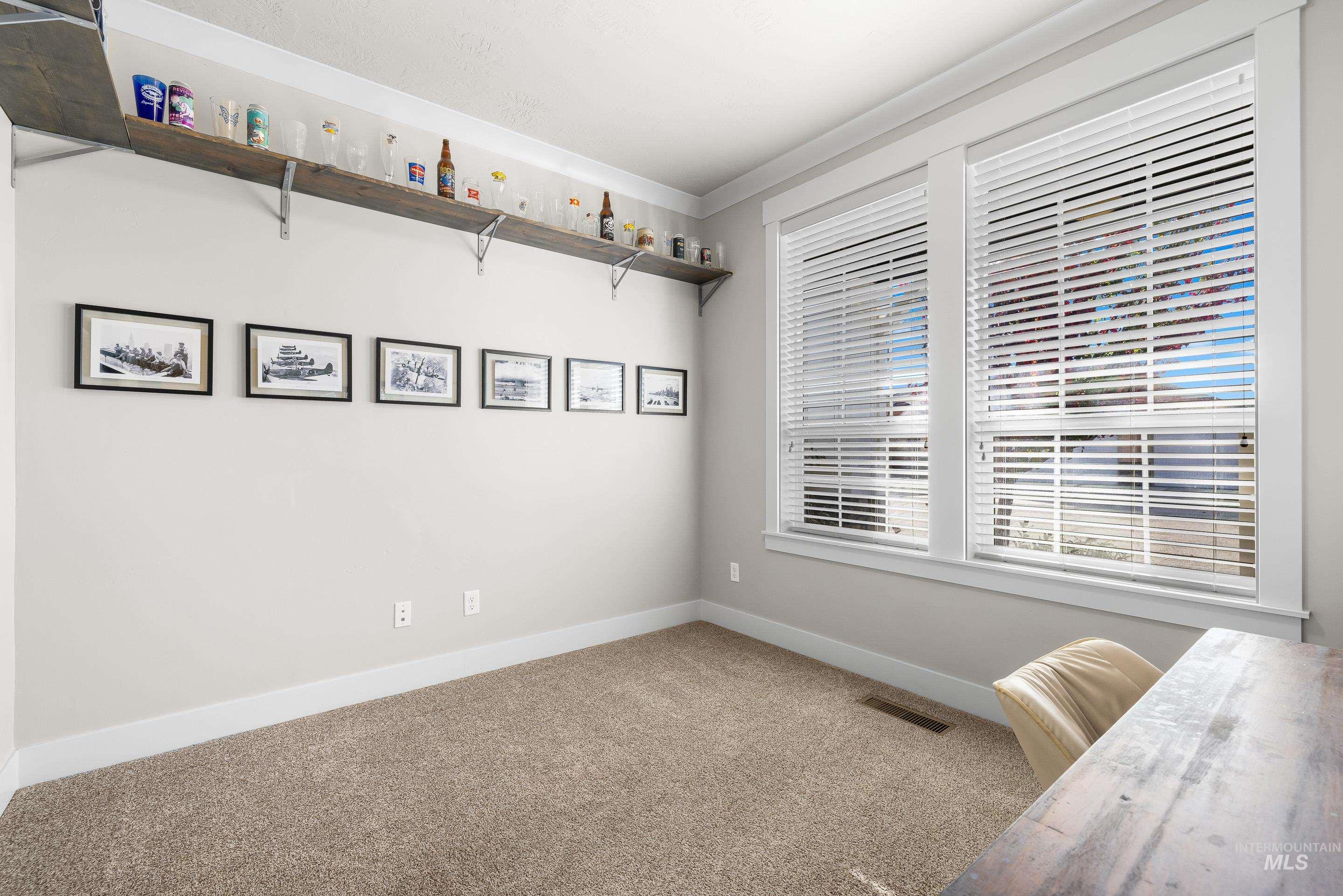 Unfurnished room featuring carpet and ornamental molding