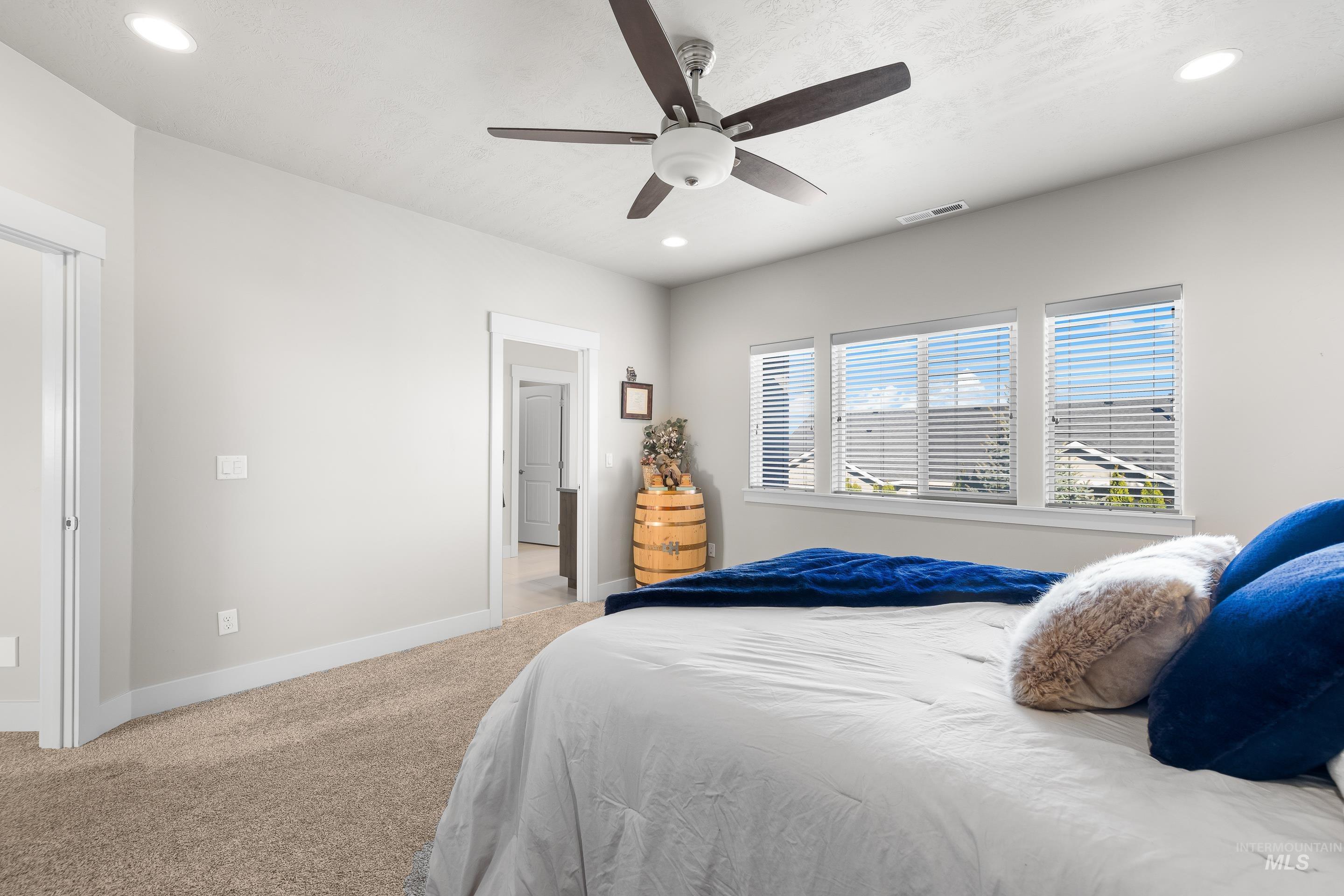 Bedroom with light carpet, recessed lighting, and ceiling fan