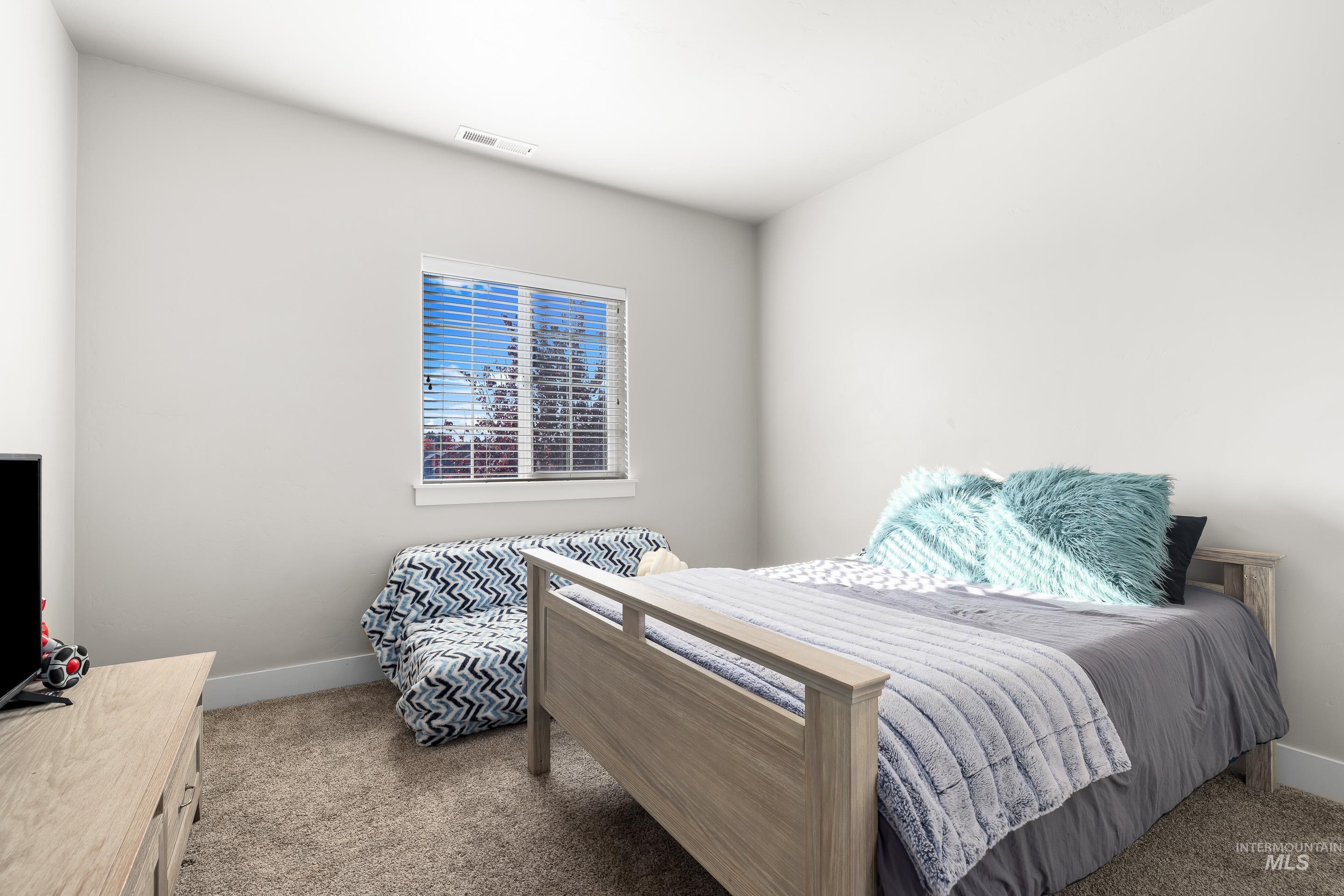 Carpeted bedroom with baseboards