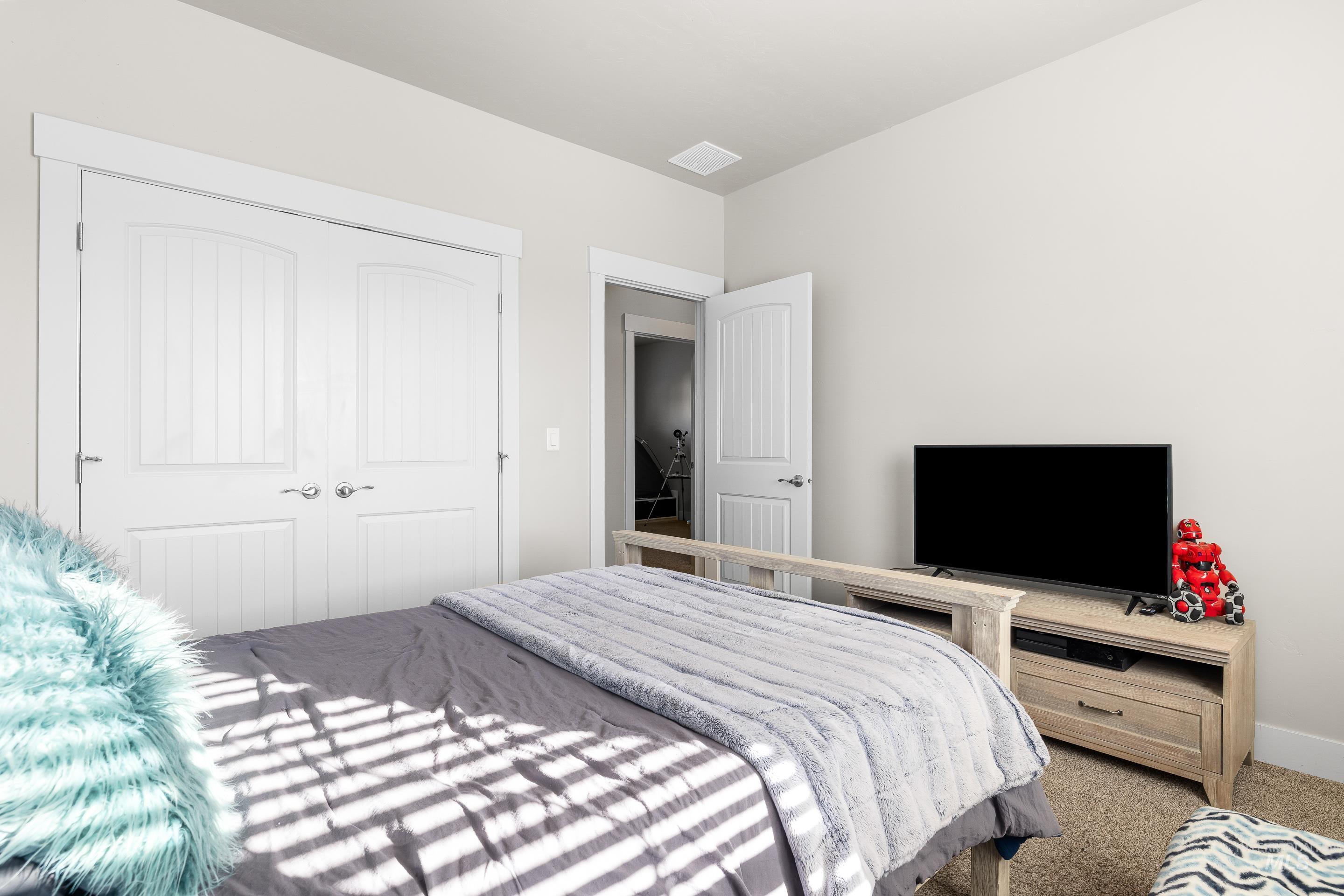 Bedroom featuring carpet floors and a closet