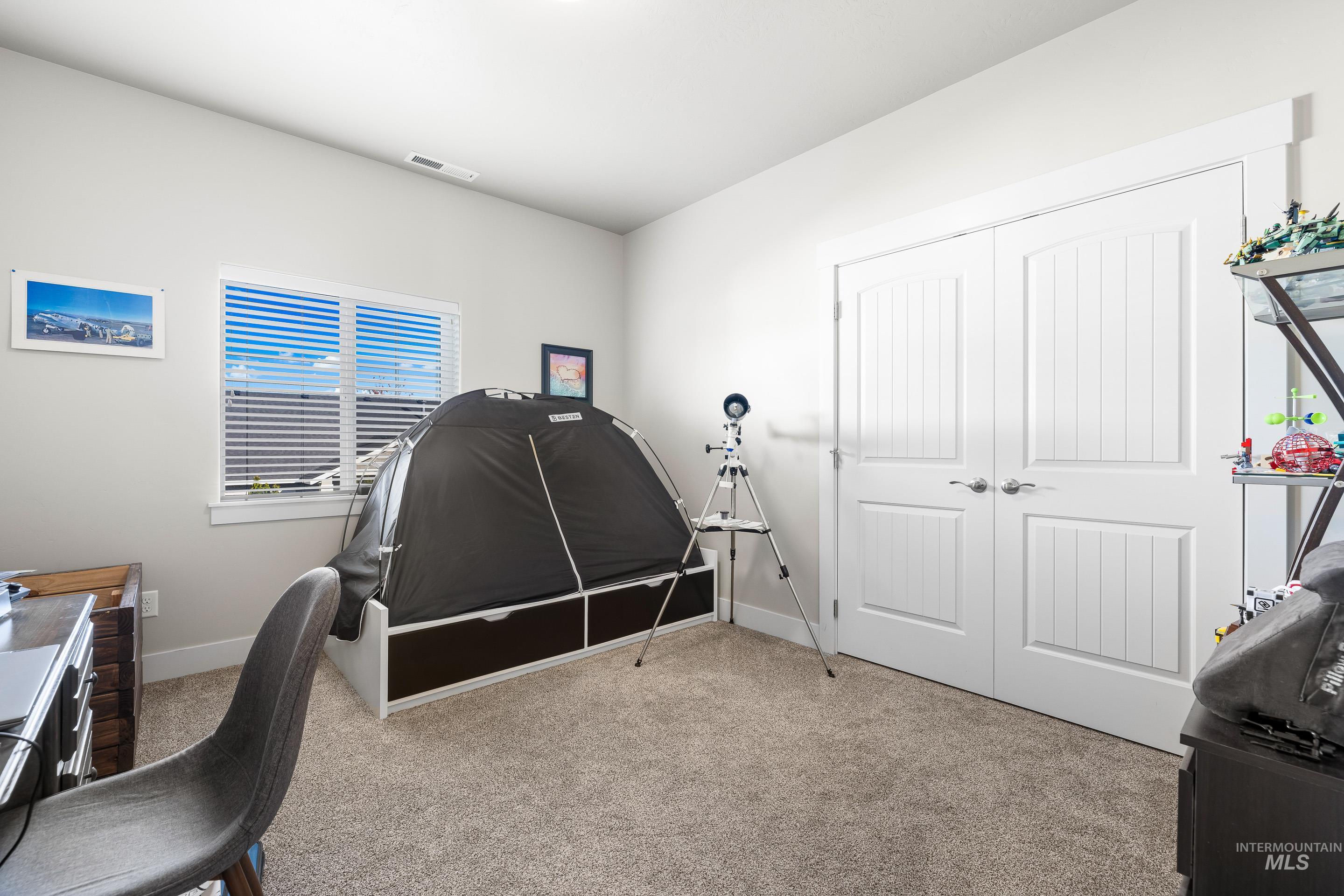 Home office featuring light colored carpet and baseboards