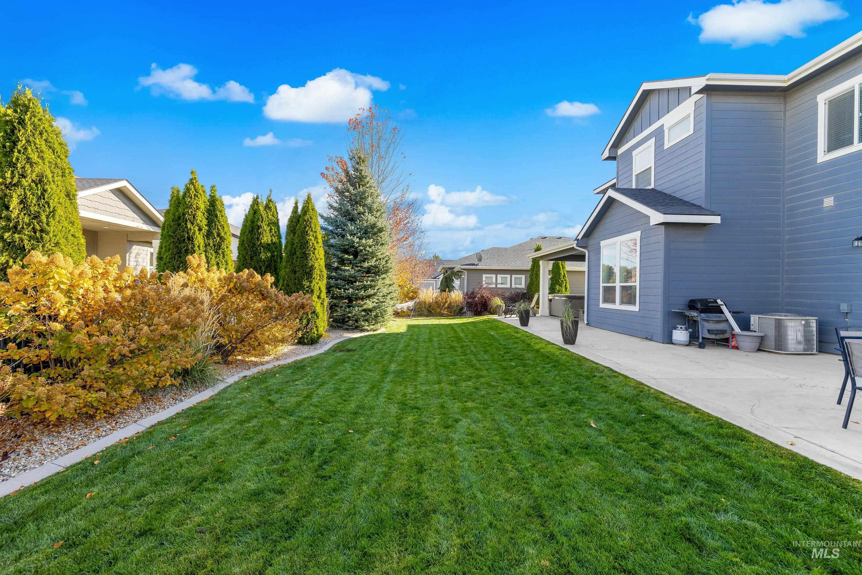 View of green lawn featuring a patio