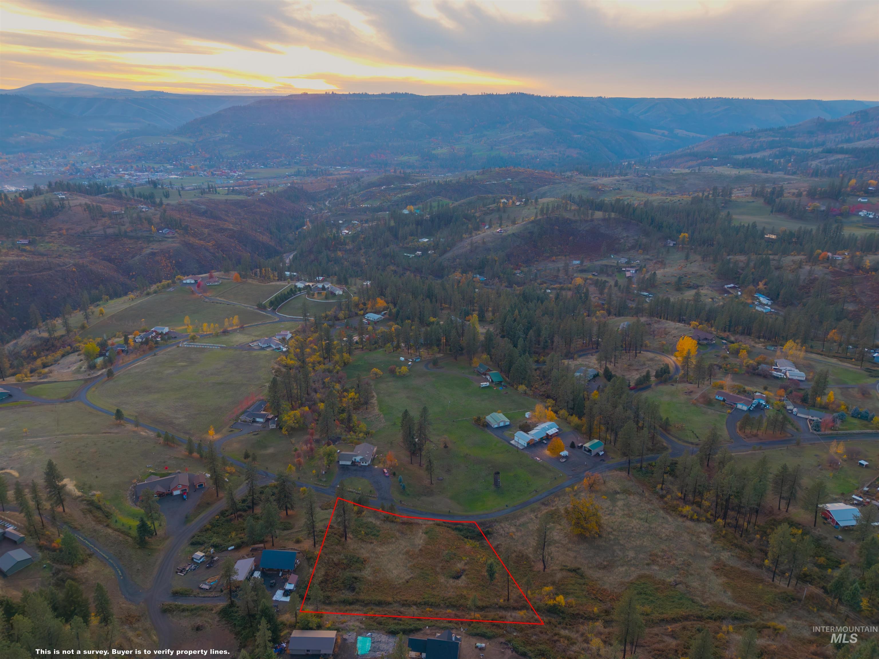 Aerial view of property and surrounding area featuring property boundaries highlighted and mountains