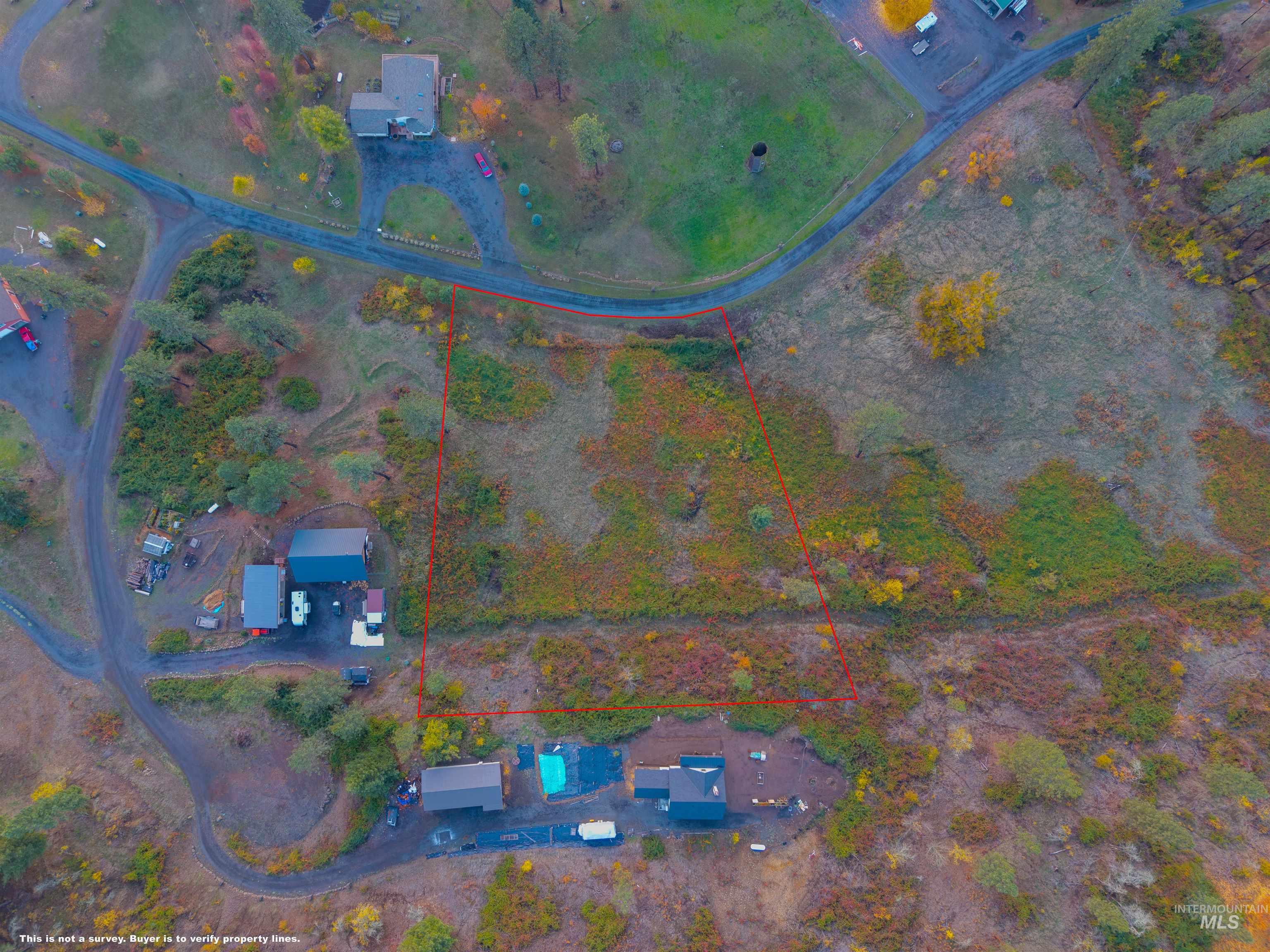 Aerial view of property and surrounding area featuring property parcel outlined