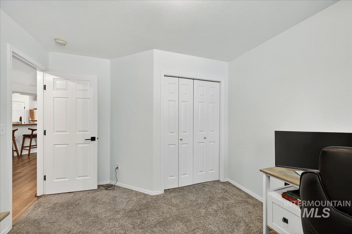 Home office featuring light carpet