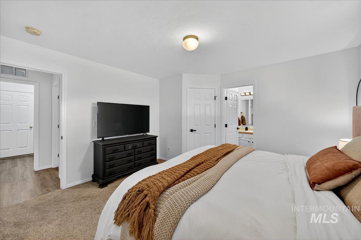 Bedroom featuring carpet and baseboards