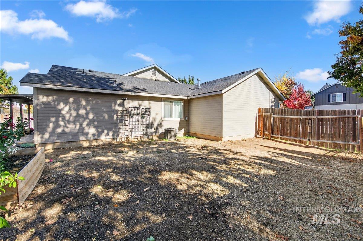 Back of house featuring roof with shingles