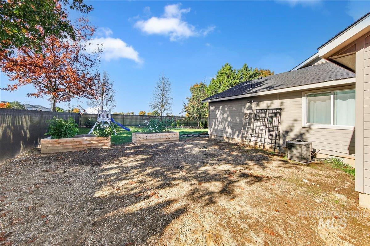 Fenced backyard with a garden