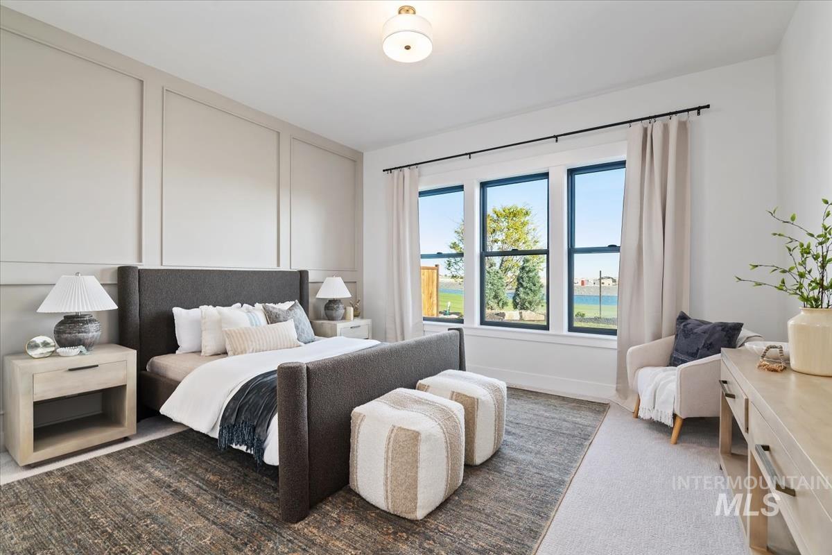 Bedroom featuring carpet and baseboards