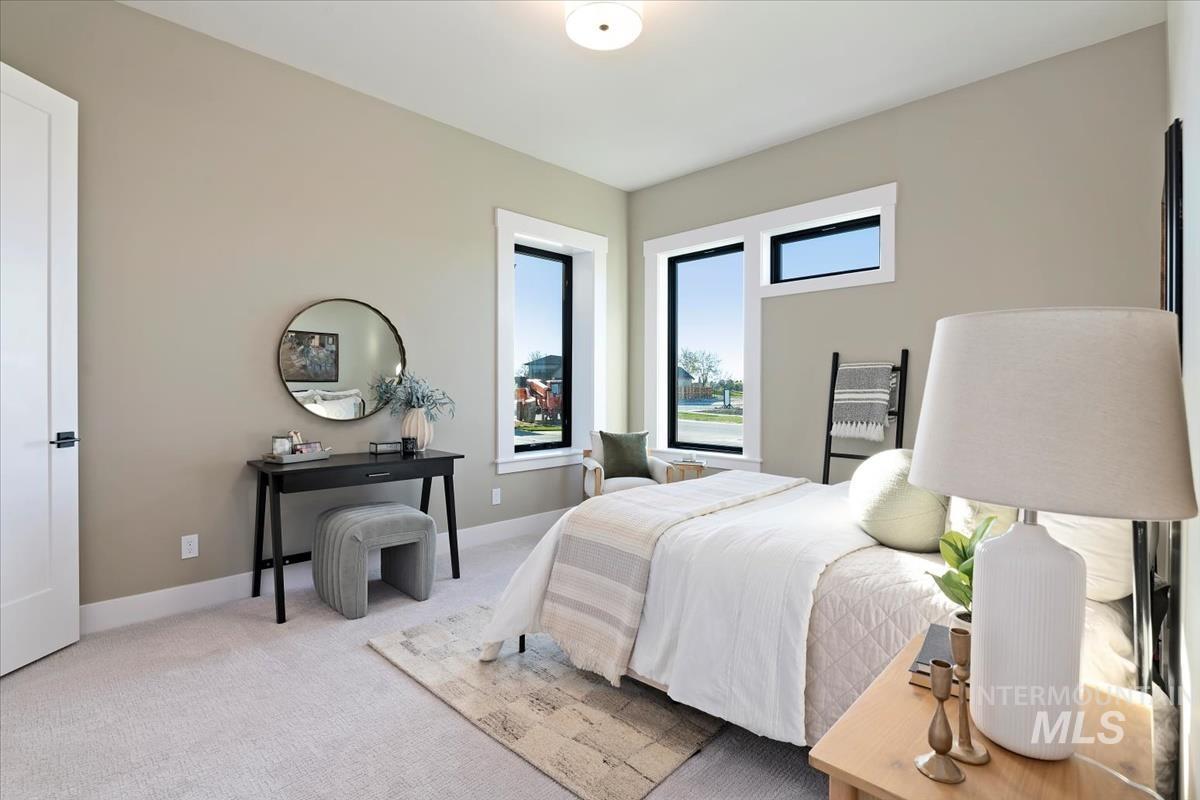 Bedroom featuring carpet and baseboards