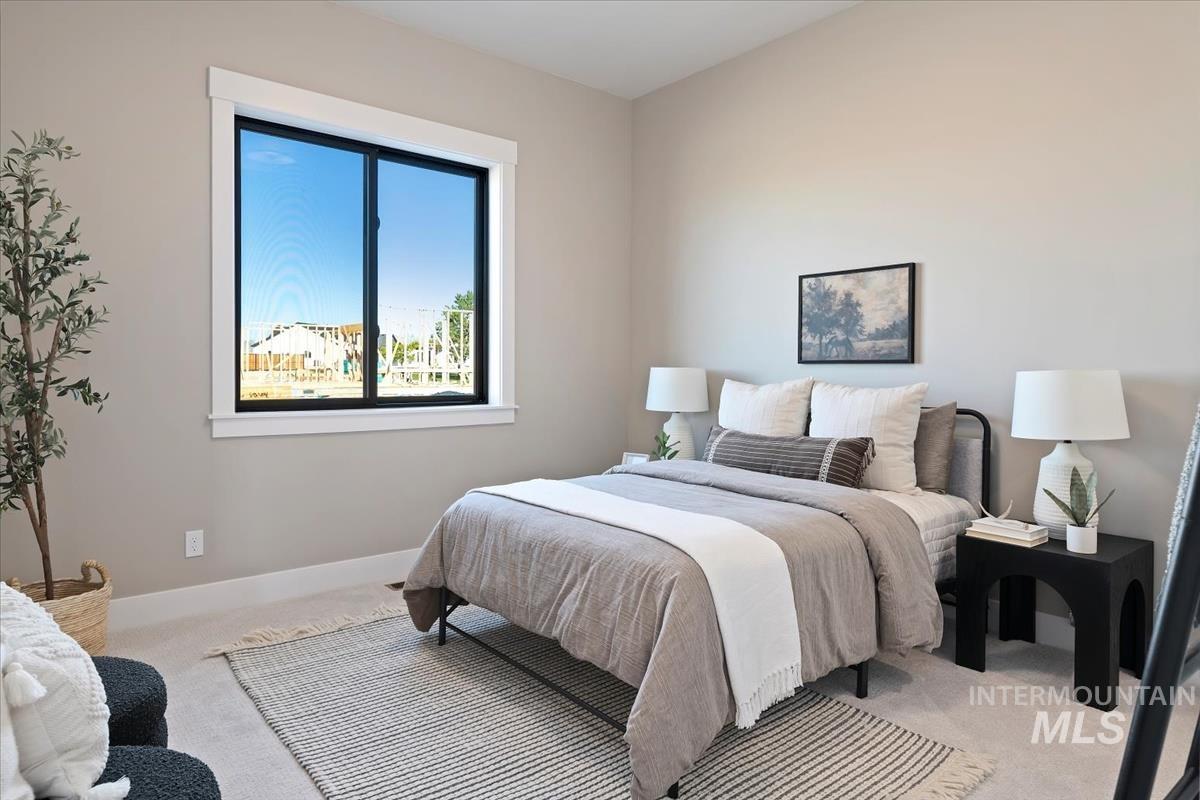 Carpeted bedroom with baseboards