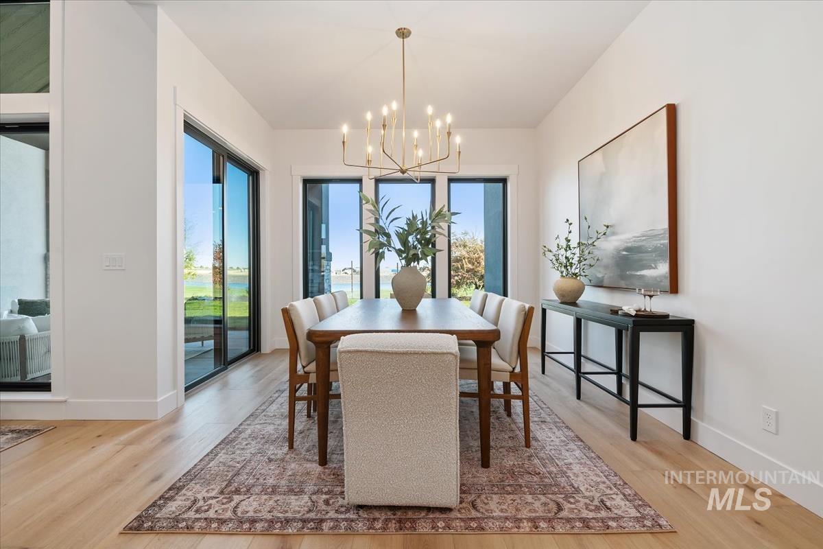 Dining room featuring light wood-type flooring and a chandelier