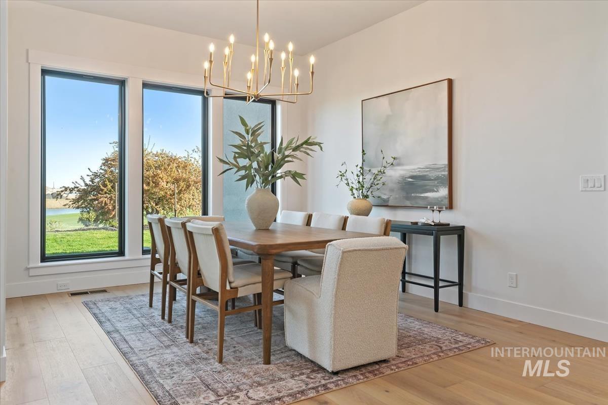 Dining area featuring light wood-style flooring and a chandelier