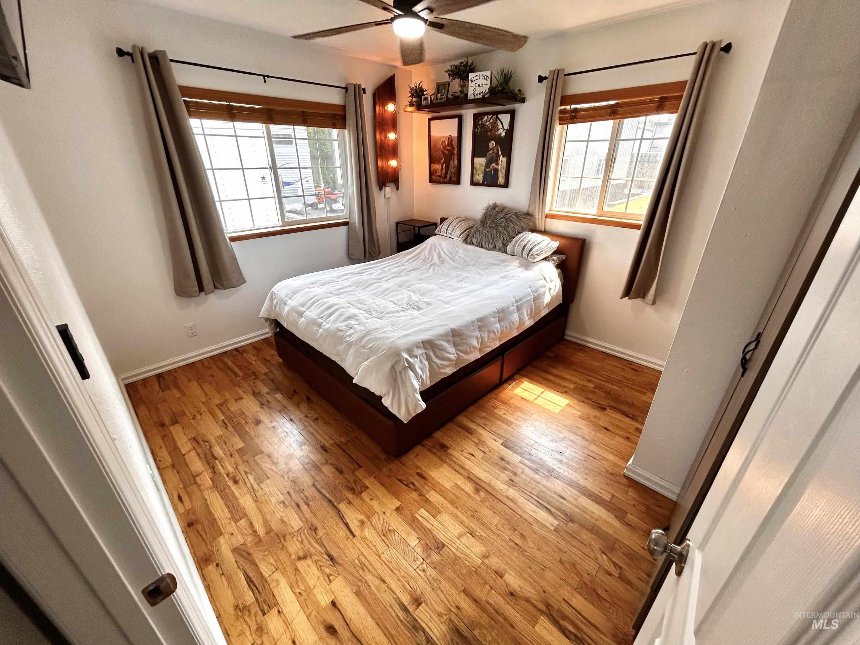 Bedroom featuring hardwood / wood-style flooring and a ceiling fan