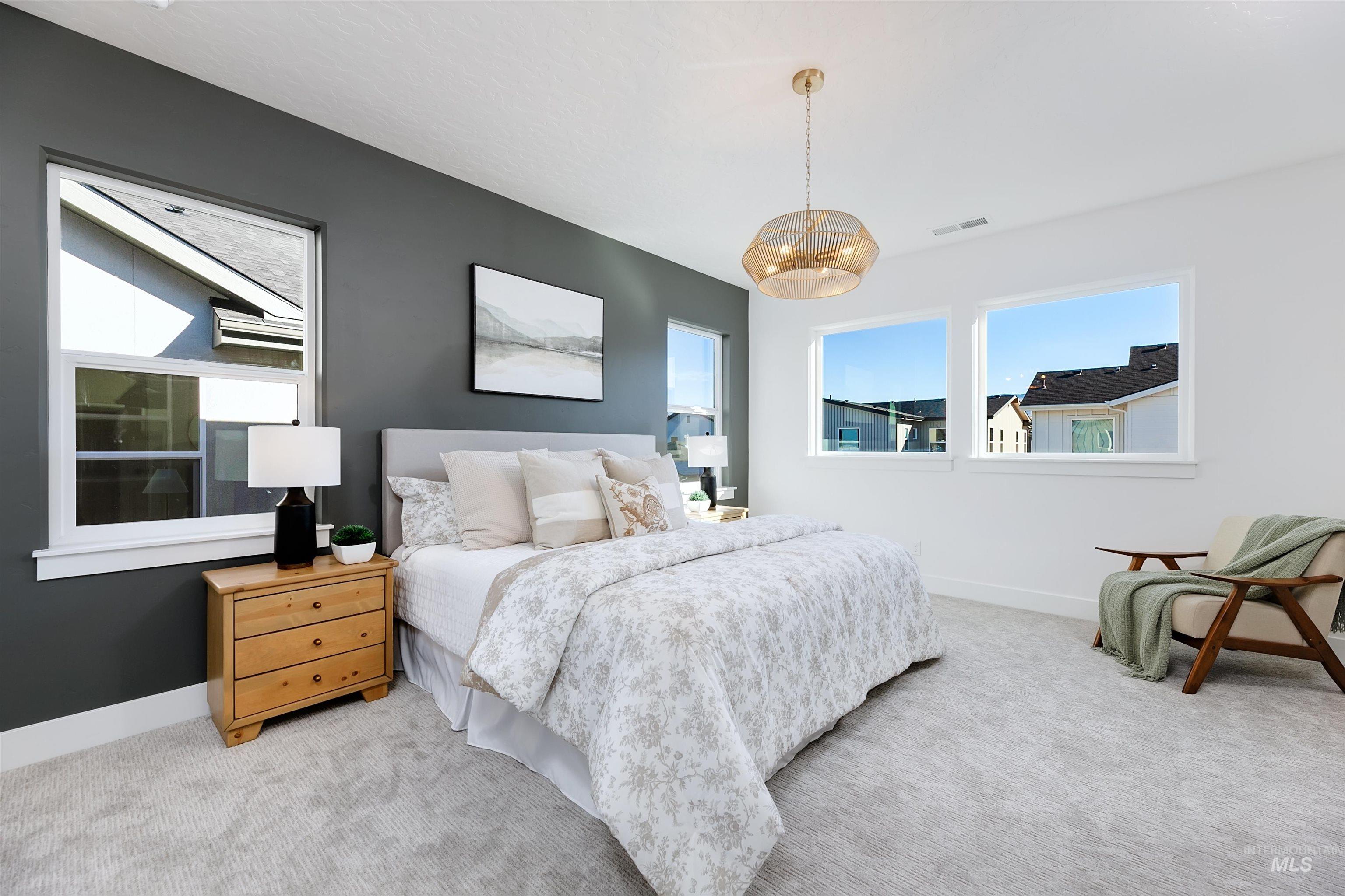 Bedroom featuring carpet and a chandelier