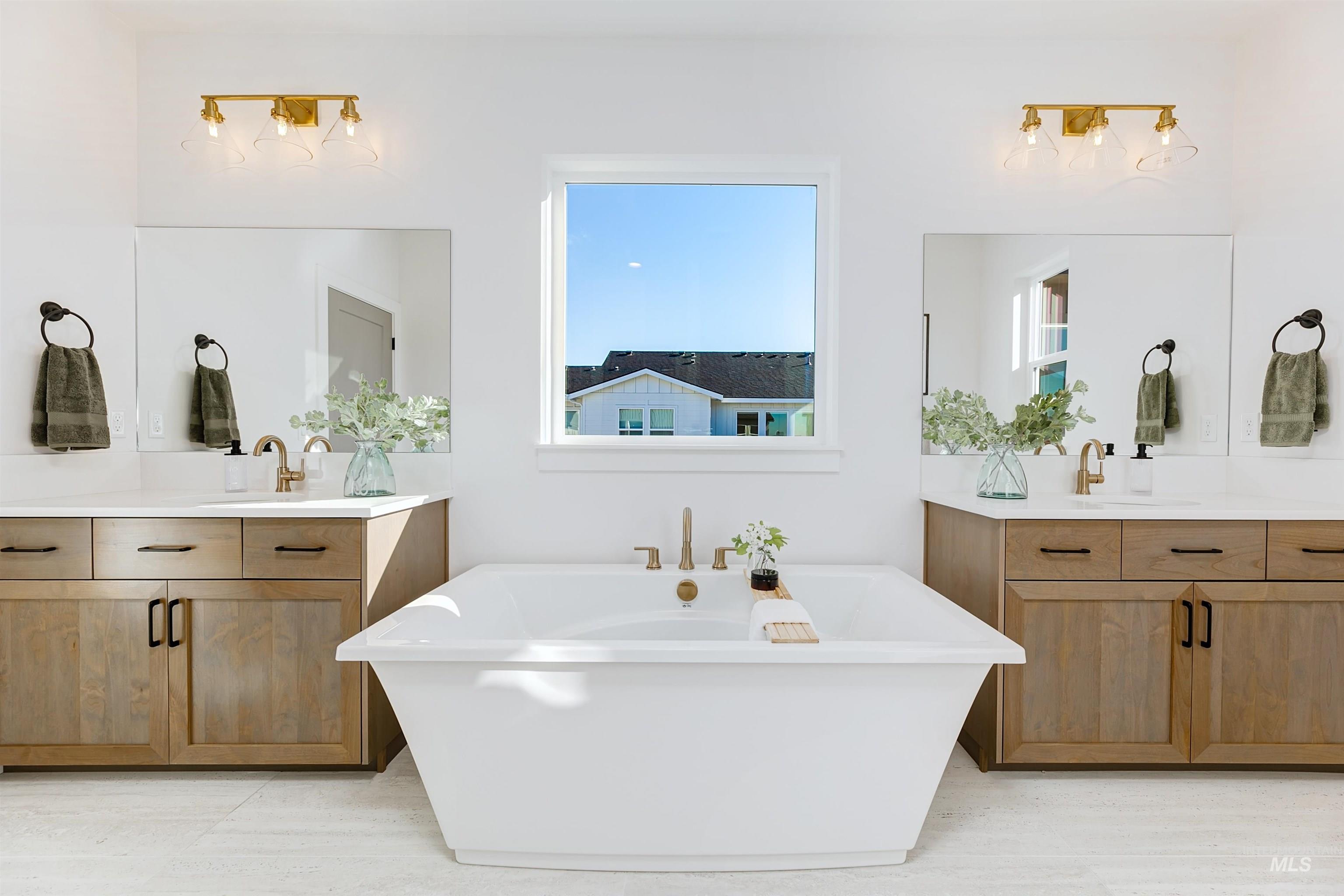 Full bathroom with a soaking tub and two vanities