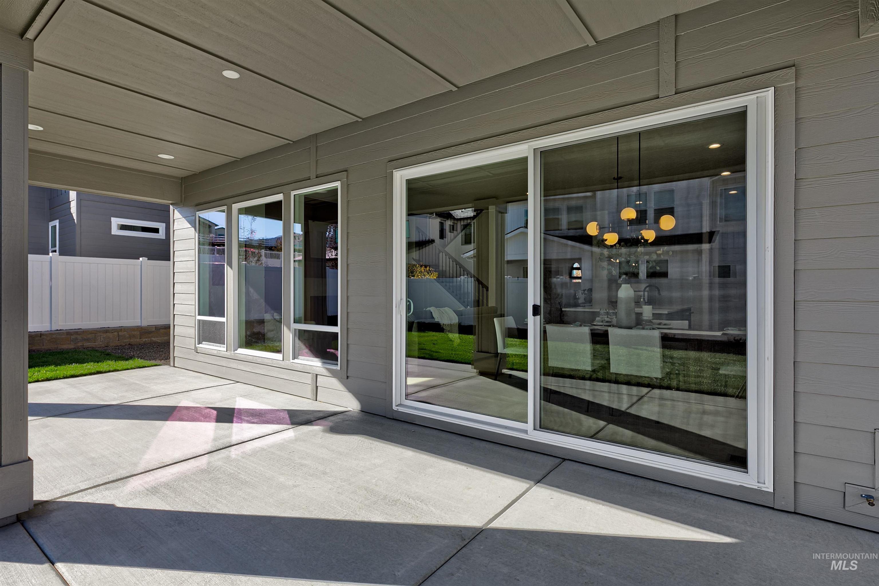 Doorway to outside featuring recessed lighting, concrete flooring, and wooden walls