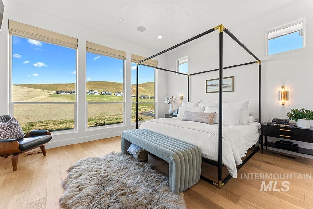 Bedroom with hardwood / wood-style floors and recessed lighting