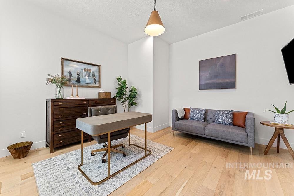 Office space featuring light wood-type flooring and baseboards