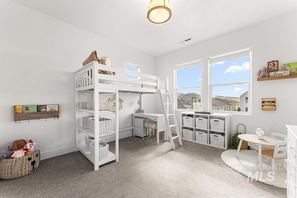 Bedroom with carpet flooring and baseboards