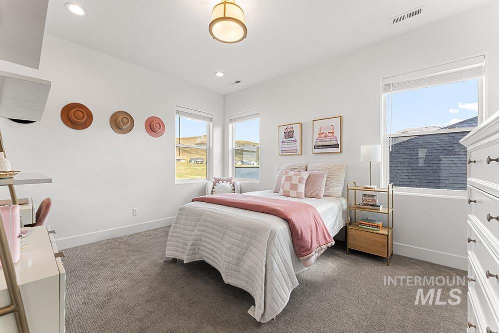 Bedroom with light colored carpet and recessed lighting