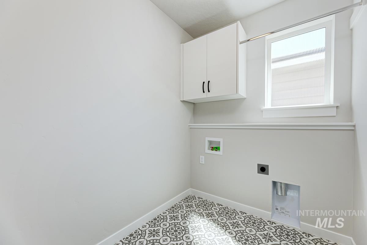 Laundry room featuring hookup for a washing machine, cabinet space, and electric dryer hookup