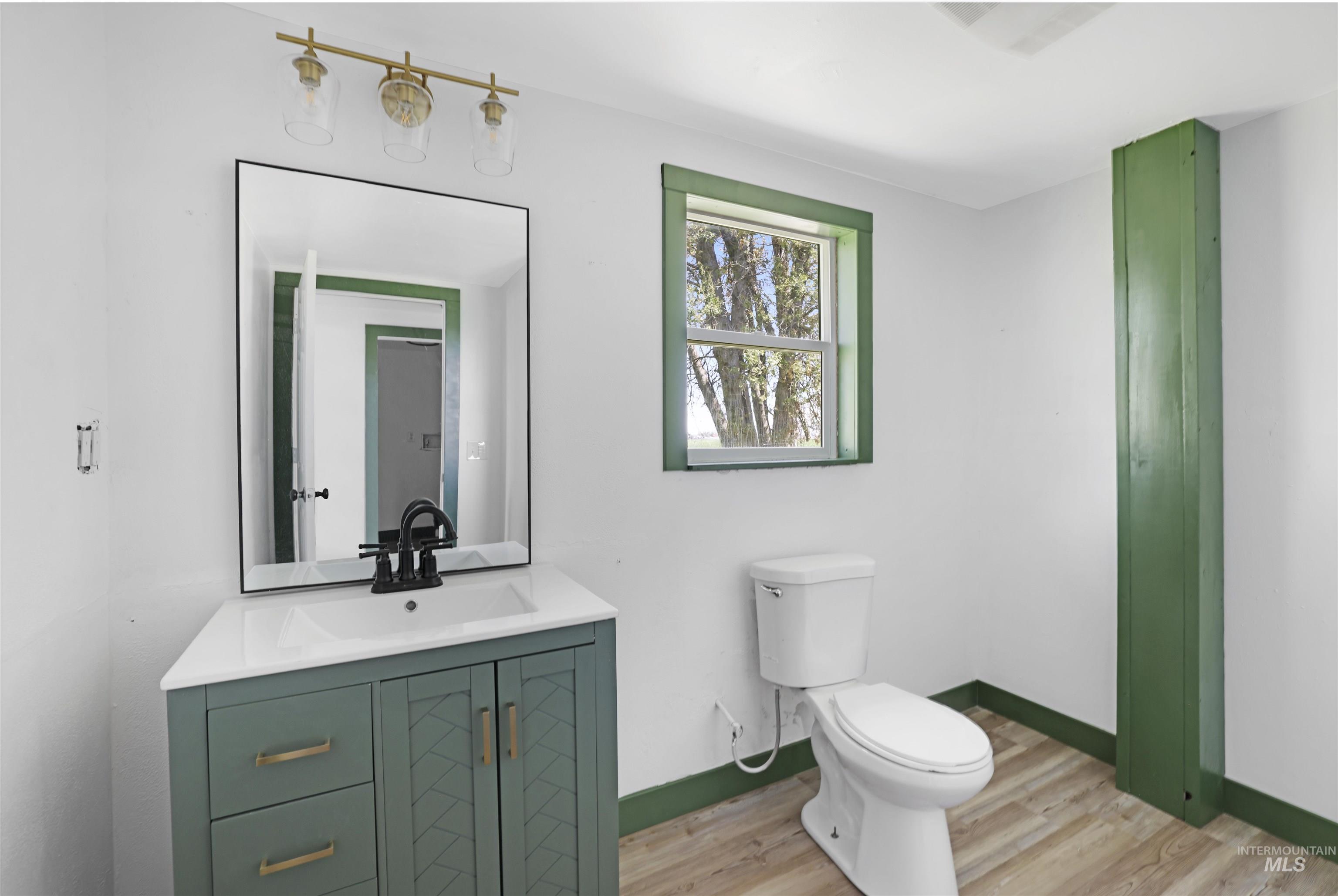 Bathroom with vanity and light wood finished floors