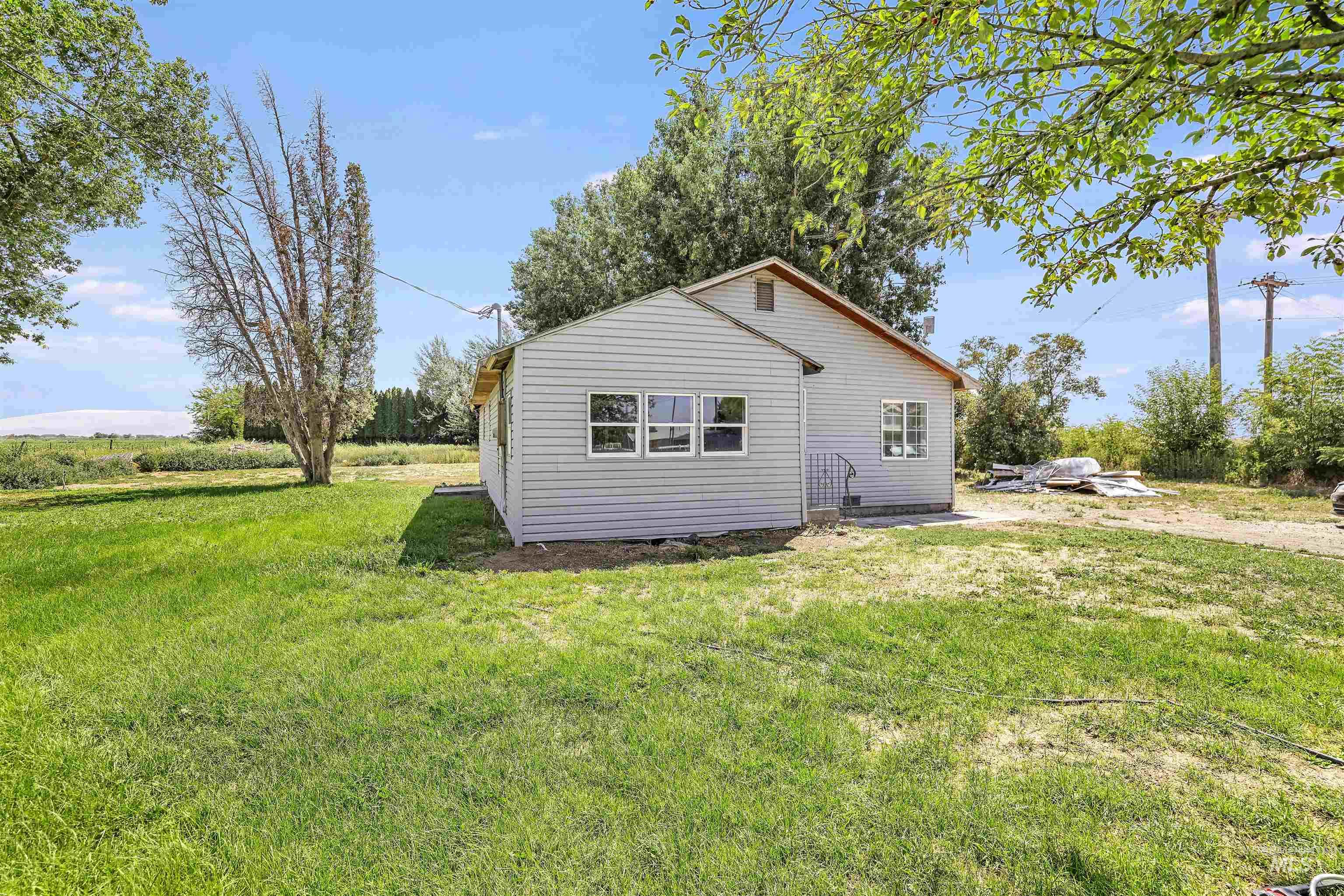 View of side of home featuring a lawn