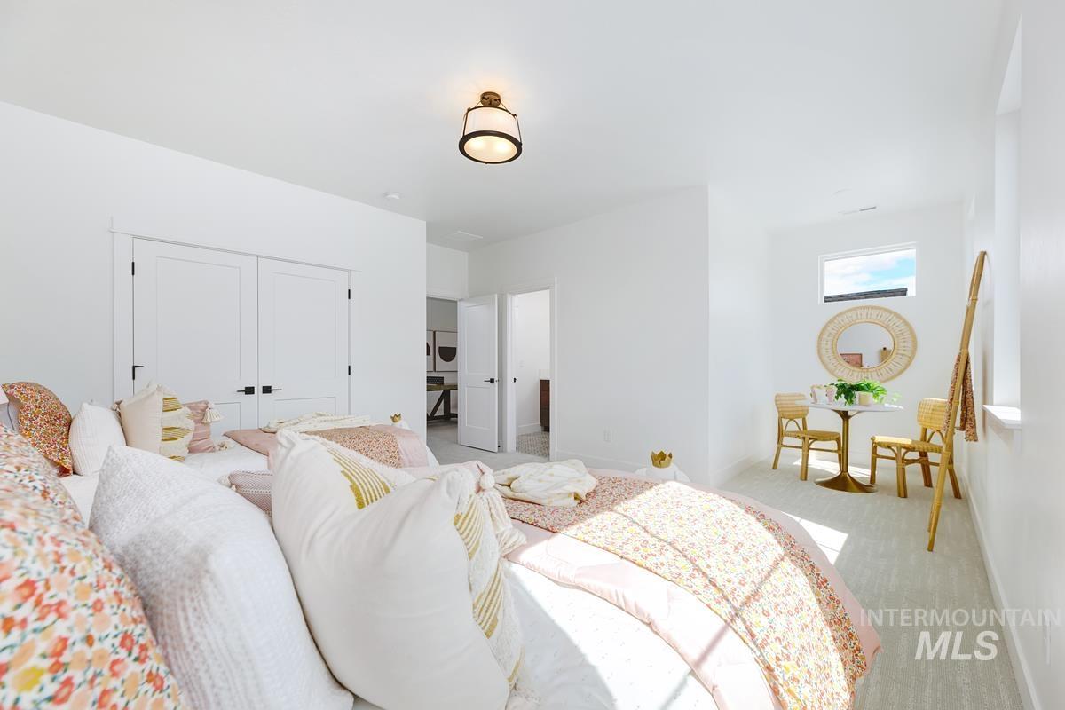 Bedroom featuring carpet flooring and a closet