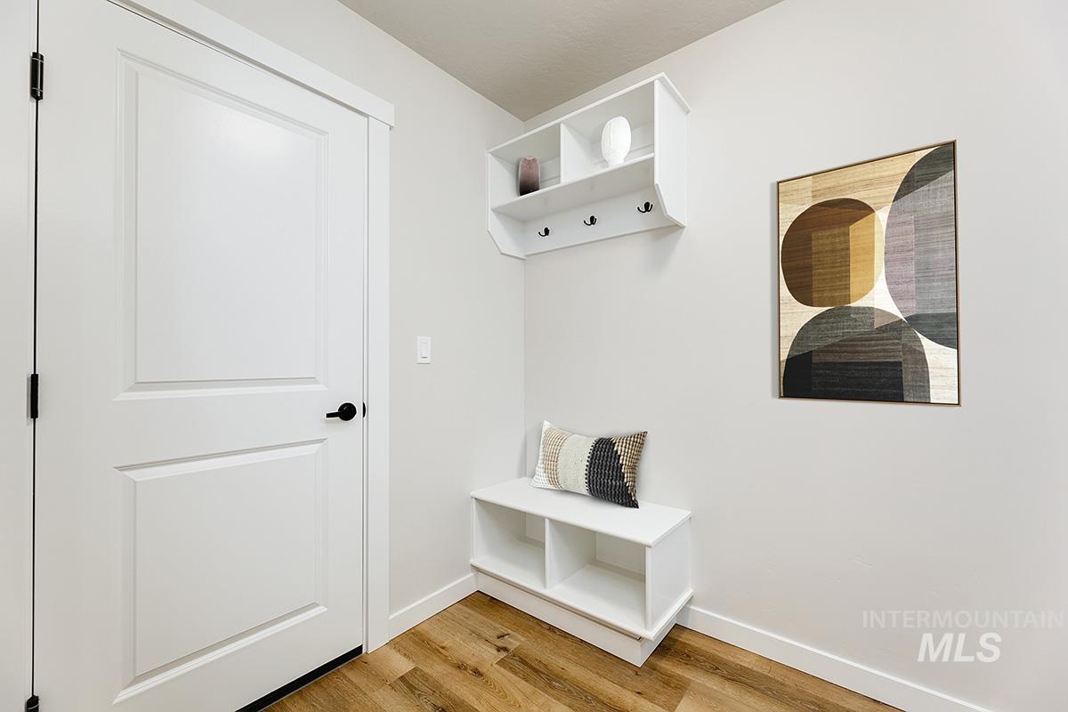 Mudroom featuring baseboards and light wood-style flooring