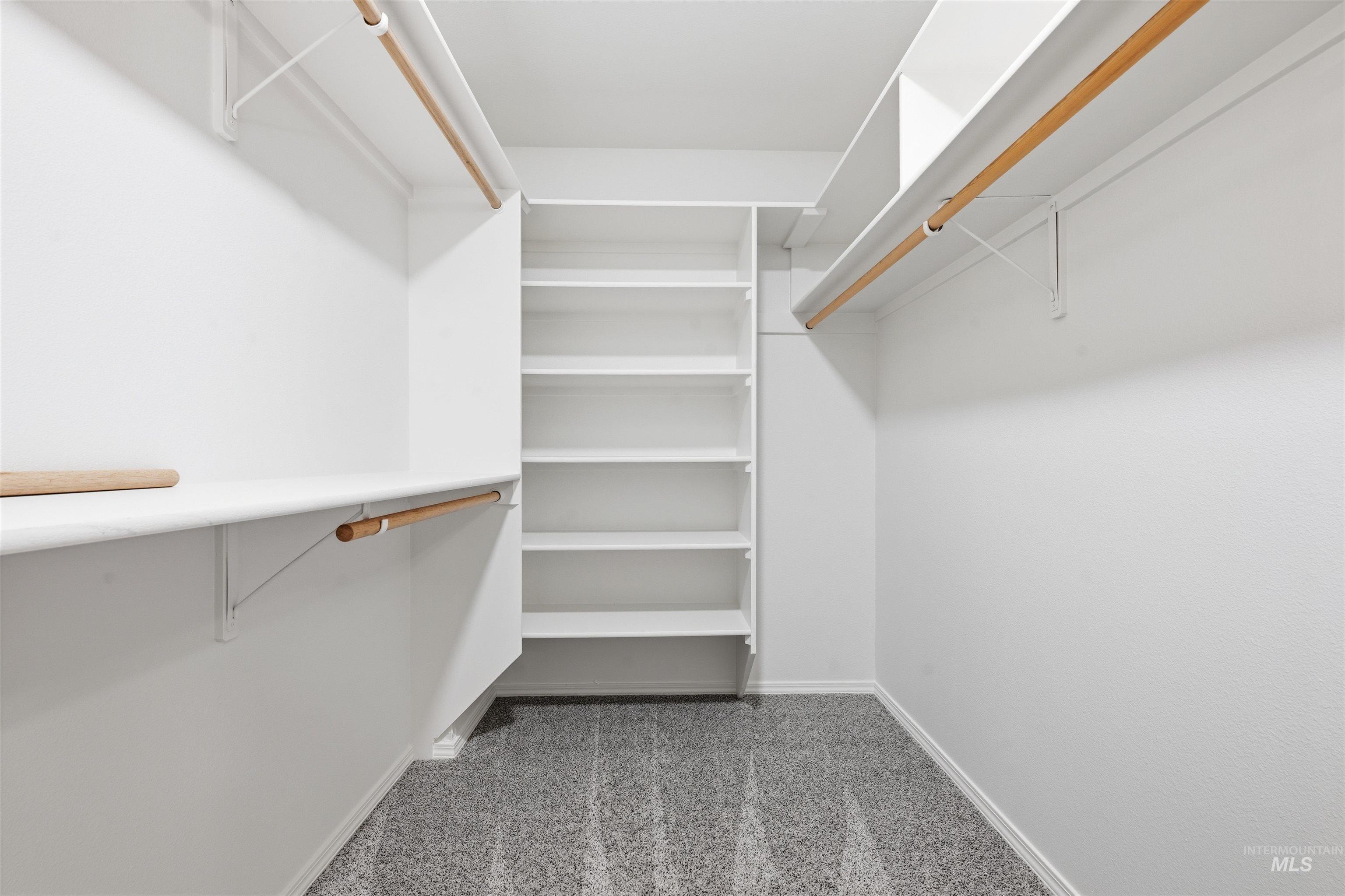 Spacious closet with light colored carpet
