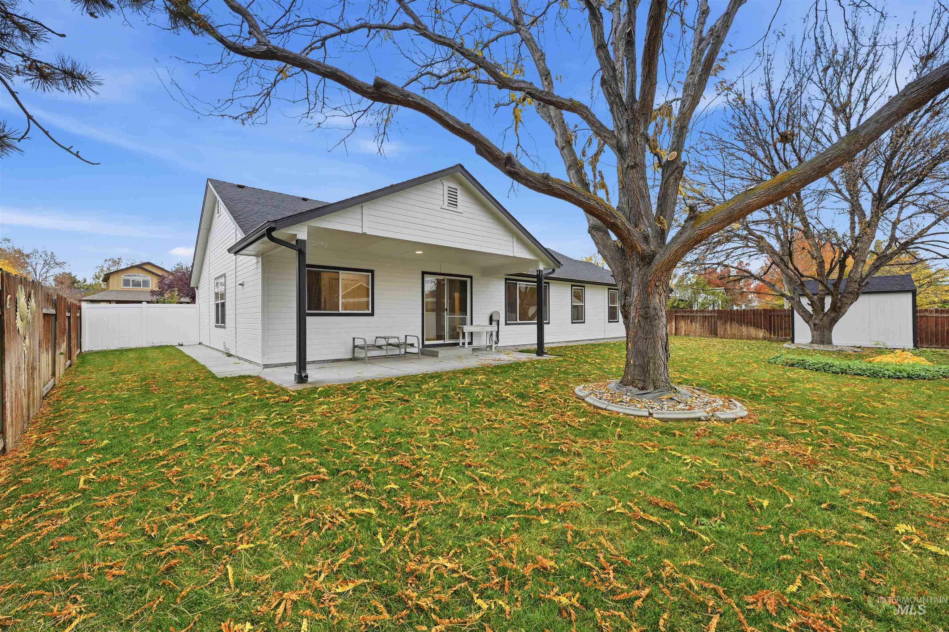 Rear view of property featuring a fenced backyard and a patio area