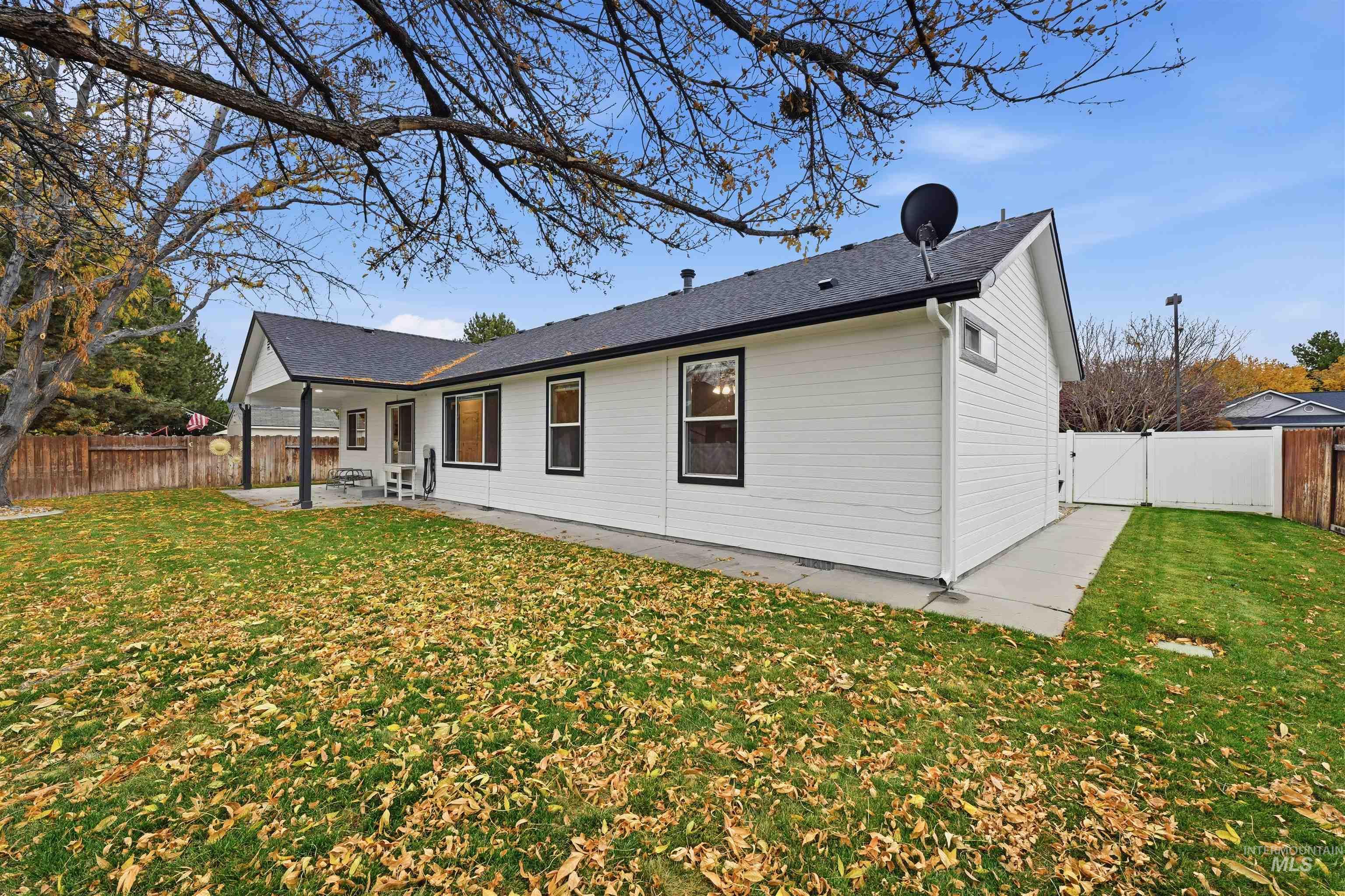 Rear view of property featuring a fenced backyard, a patio, and a gate