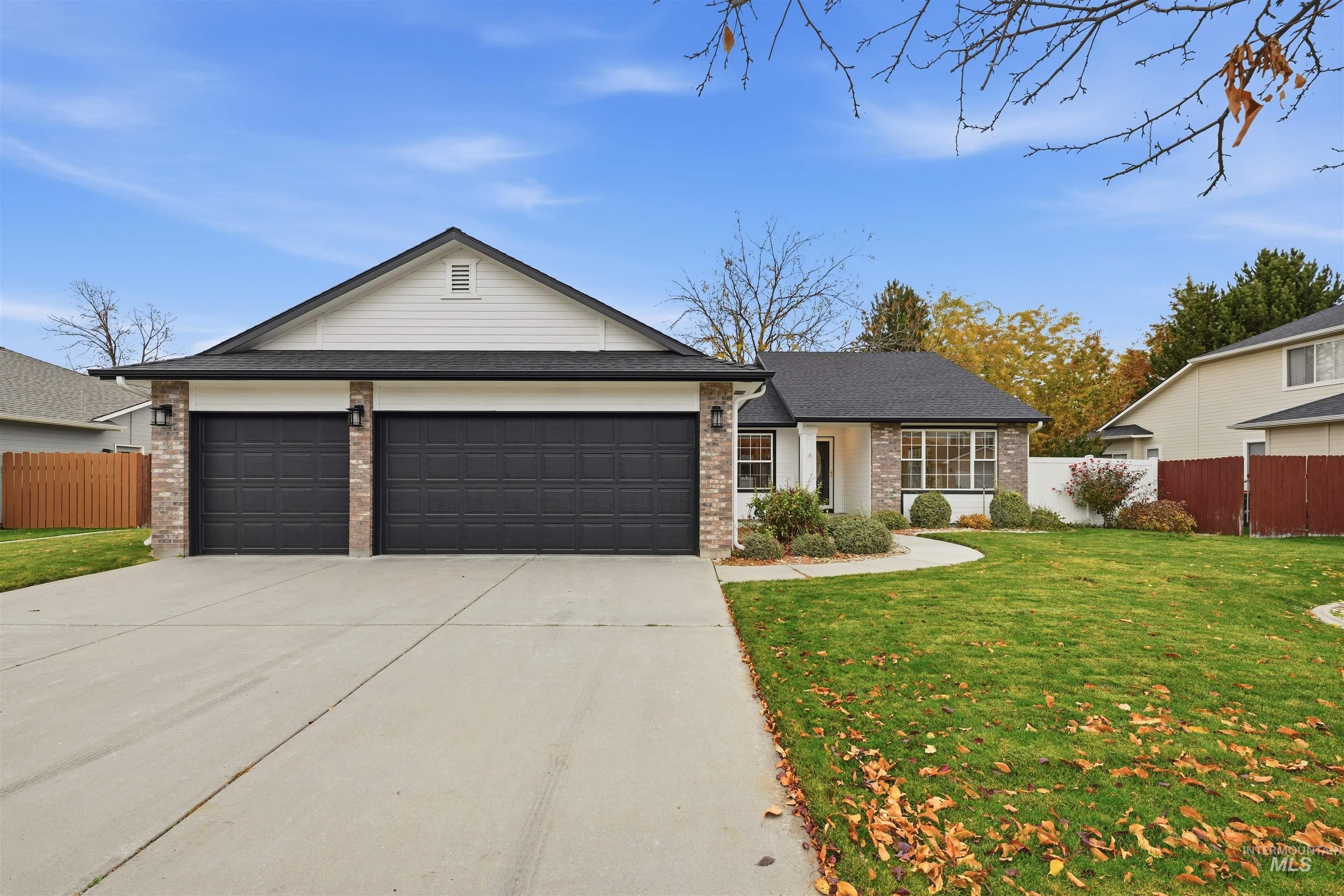 Ranch-style house featuring brick siding, concrete driveway, and an attached garage