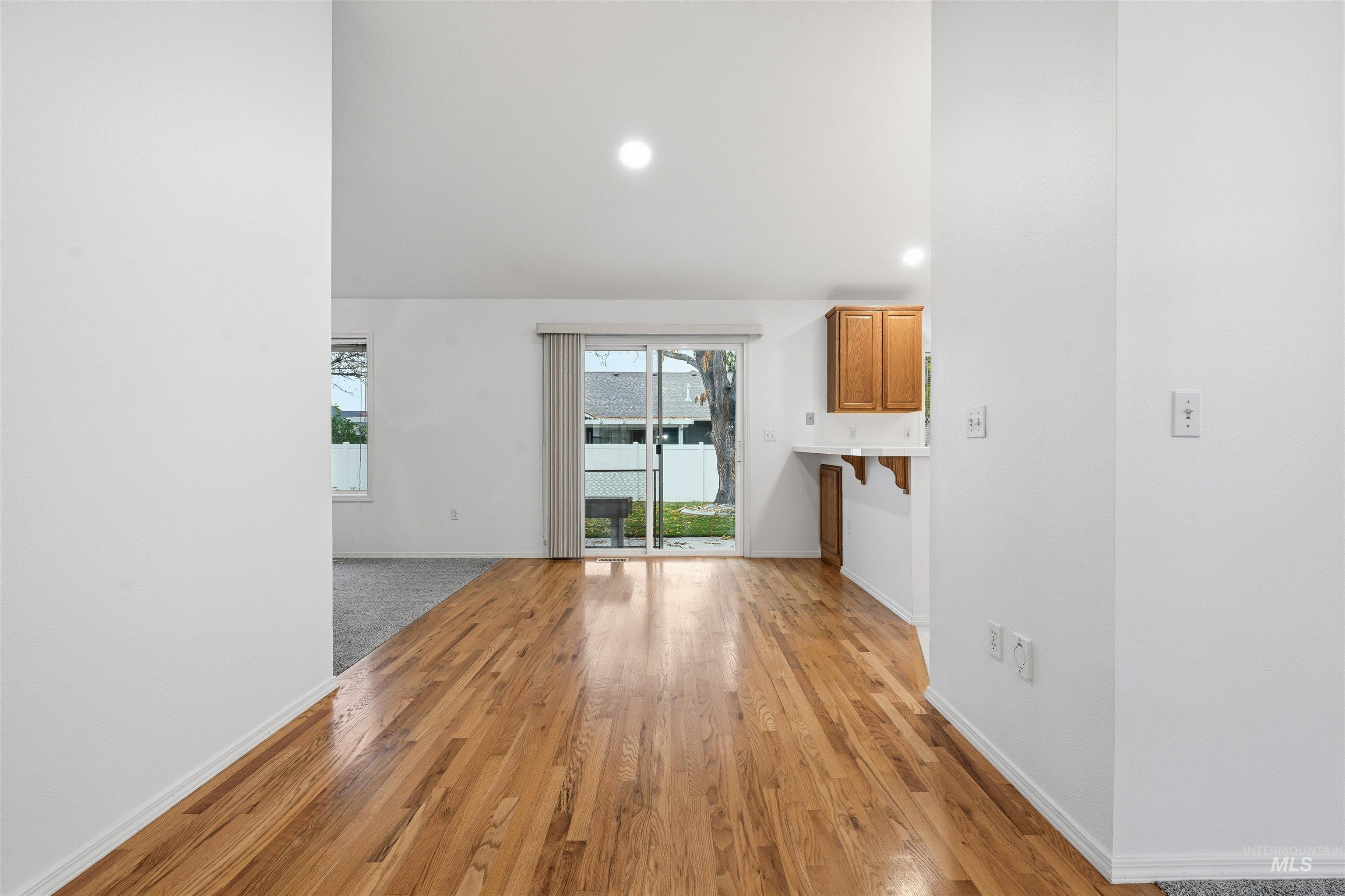 Unfurnished living room with light wood finished floors and recessed lighting