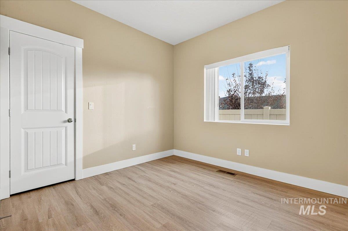 Unfurnished room featuring baseboards and light wood-style floors