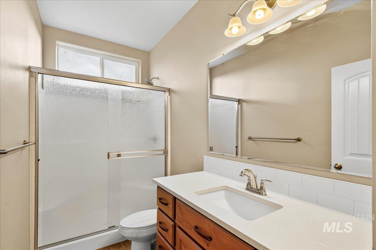 Bathroom featuring a shower stall and vanity