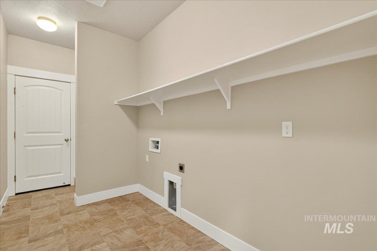 Washroom featuring hookup for an electric dryer, washer hookup, and a textured ceiling